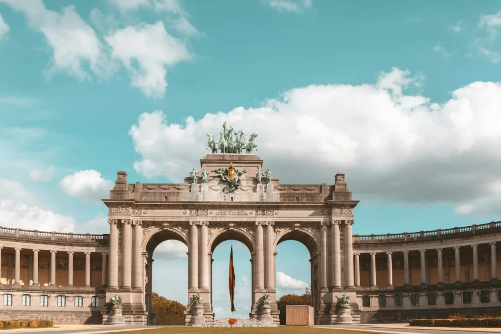 The triumphal arch of Cinquantenaire with a large Belgian flag hanging in Brussels