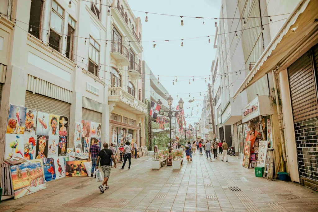 Pedestrian street with paintings displayed outside buildings in Santo Domingo