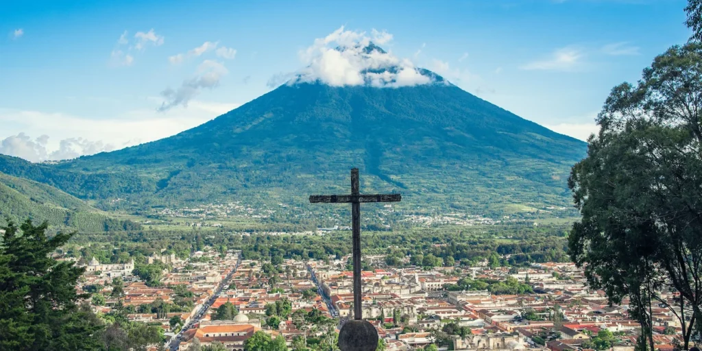 The stone cross at Cerro de la Cruz overlooking the city of Antigua and Volcán de Agua in Guatemala
