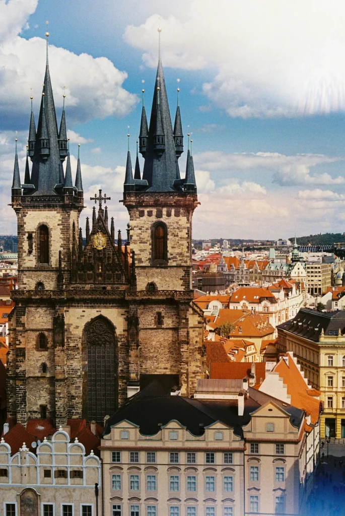 Gothic spires of Church of Our Lady before Týn rising above terracotta roofs in Prague