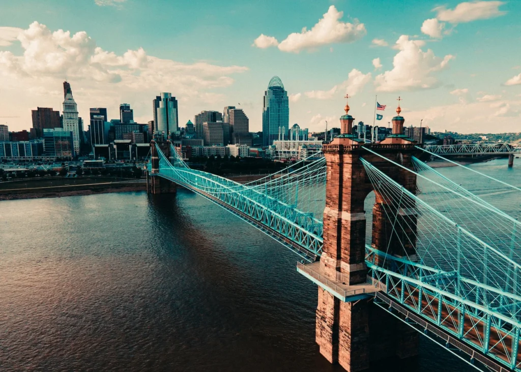 John A. Roebling Suspension Bridge stretching across the river toward Cincinnati skyscrapers