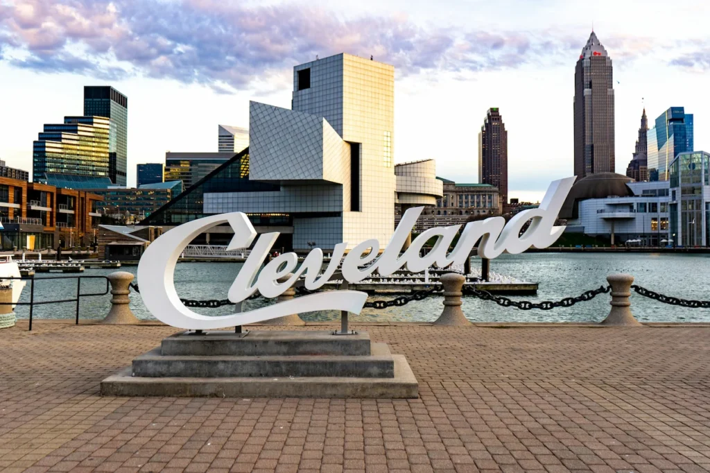 Cleveland script sign North Coast Harbor Rock and Roll Hall of Fame building skyline background