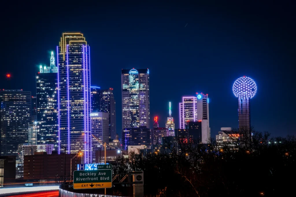 The illuminated Dallas skyline at night featuring Bank of America Plaza and Reunion Tower