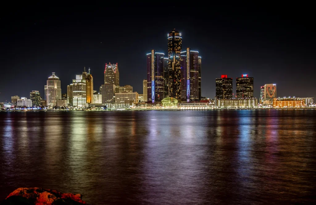 Detroit skyline illuminated at night showcasing the Renaissance Center along the waterfront