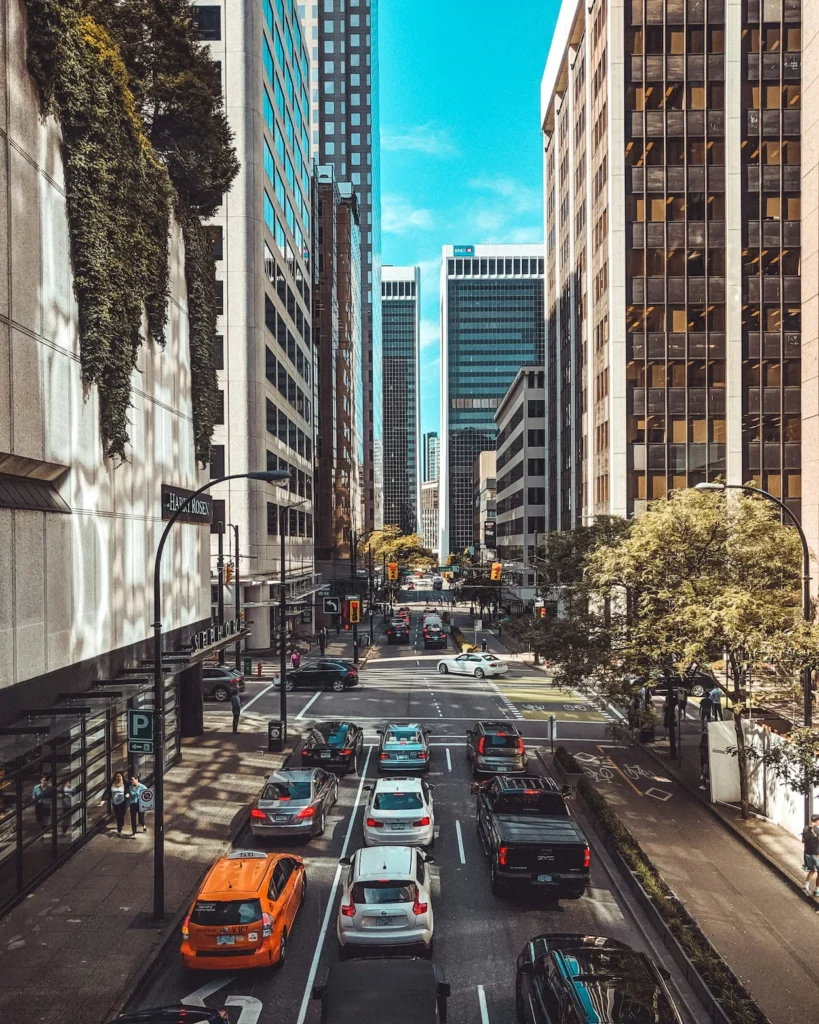 Traffic driving between skyscrapers on Dunsmuir Street in downtown Vancouver