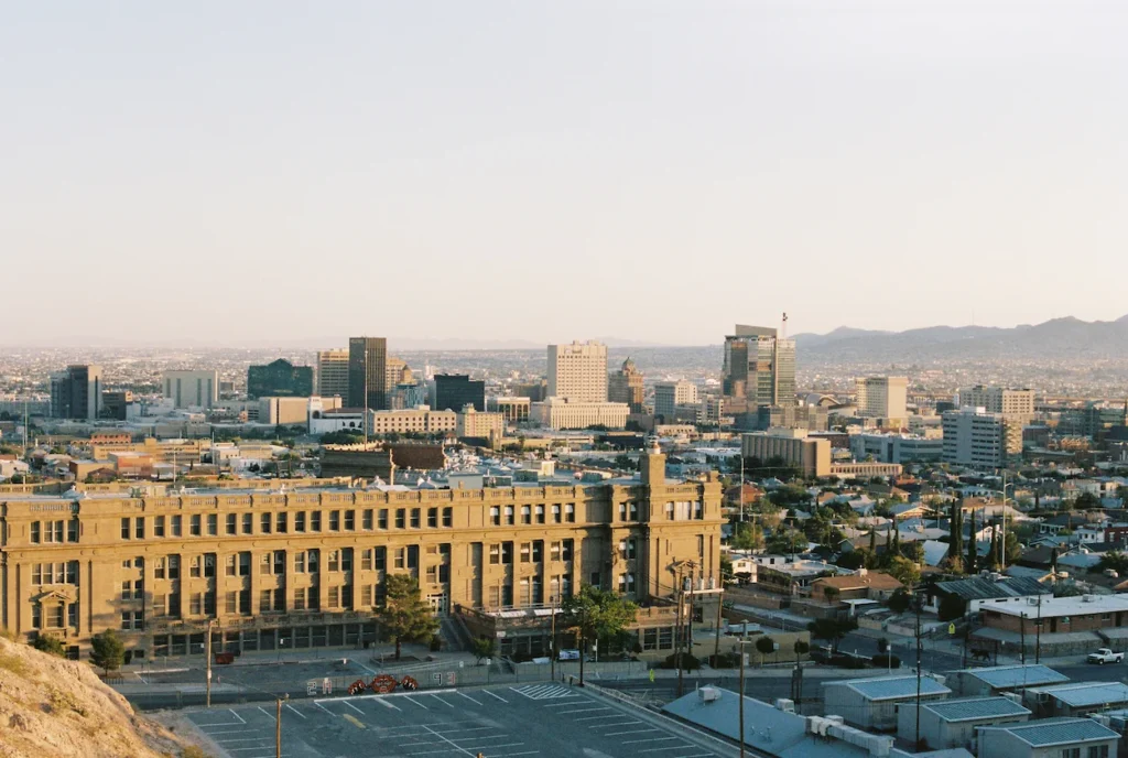 Downtown El Paso skyline and Franklin Mountains behind the historic El Paso High School building