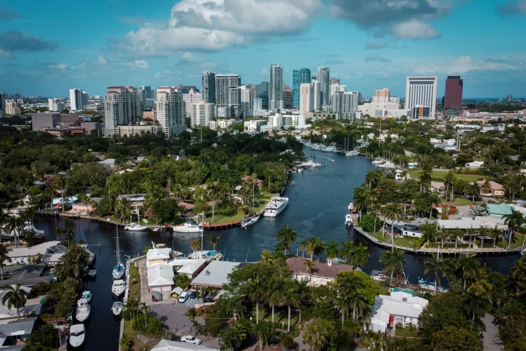 Aerial view of boats on the New River leading toward the downtown skyscraper skyline in Fort Lauderdale, Florida