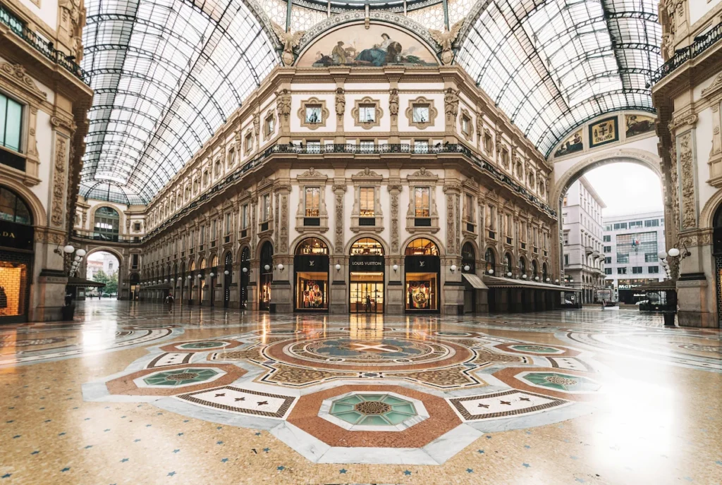Intricate mosaic tile floor and glass-vaulted ceiling inside the Galleria Vittorio Emanuele II in Milan