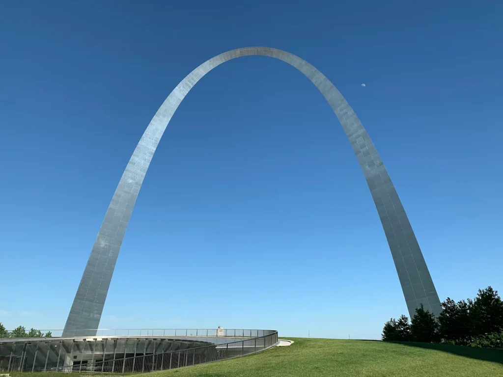 Gateway Arch stainless steel monument blue sky grassy lawn visitor center entrance