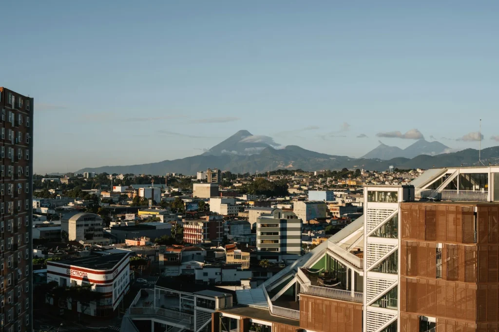Guatemala City buildings looking toward Pacaya and Agua volcanoes in the background