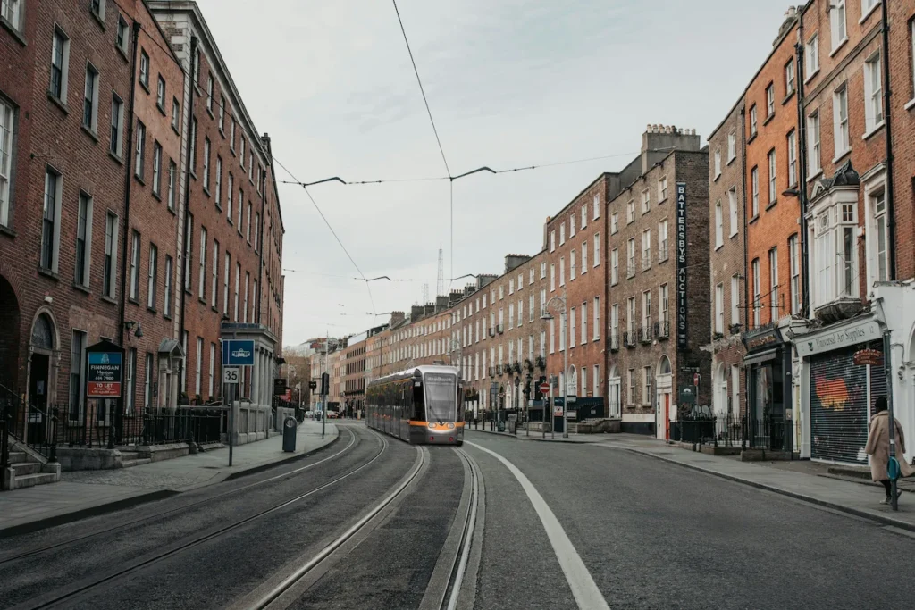Luas tram traveling down the tracks on Harcourt Street in Dublin