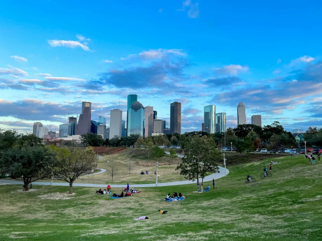 Houston skyline viewed from a grassy hill in Buffalo Bayou Park