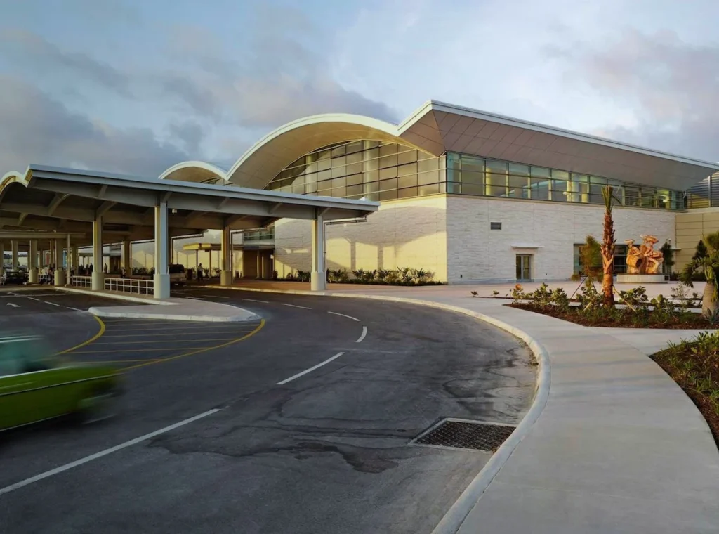 Lynden Pindling Airport terminal exterior with curved roofs