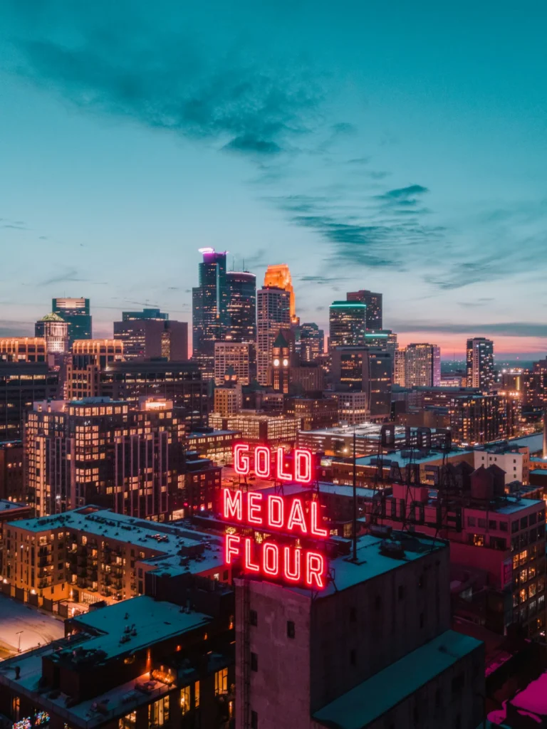 Neon red Gold Medal Flour sign on a rooftop overlooking the downtown Minneapolis skyline, Minnesota