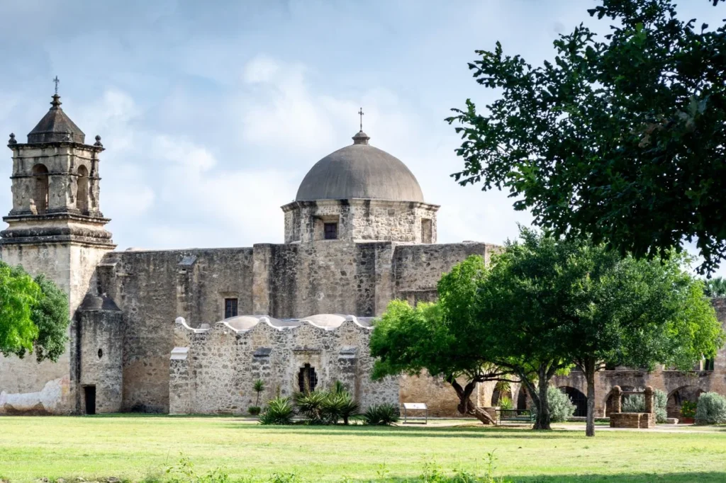Historic stone church and dome of Mission San José in San Antonio