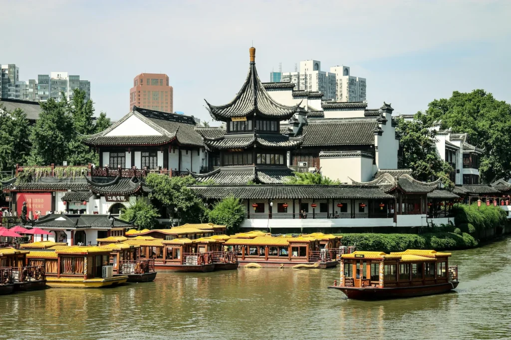 Traditional Chinese architecture at Nanjing Fuzimiao along the Qinhuai River with yellow-roofed tour boats