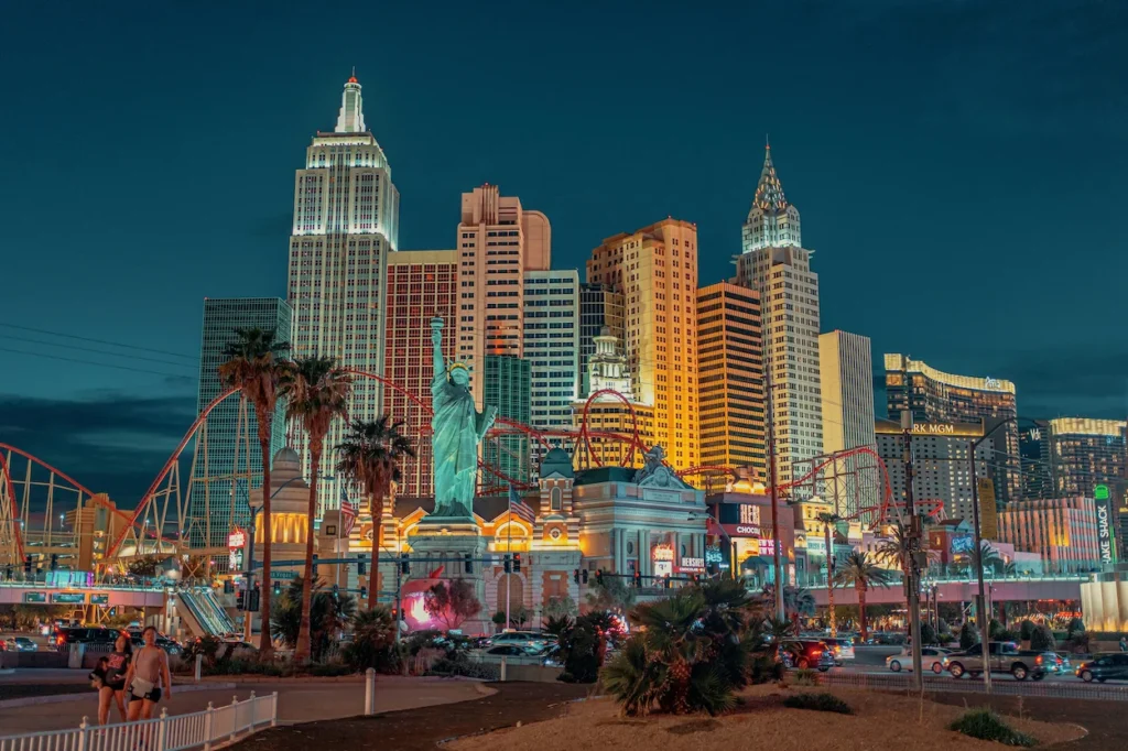 New York-New York casino resort in Las Vegas lit up at night with its replica Statue of Liberty and skyline towers