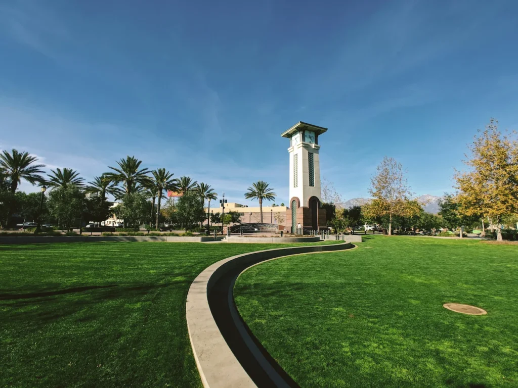 Ontario Town Square green lawn with a curved path leading toward the tall clock tower