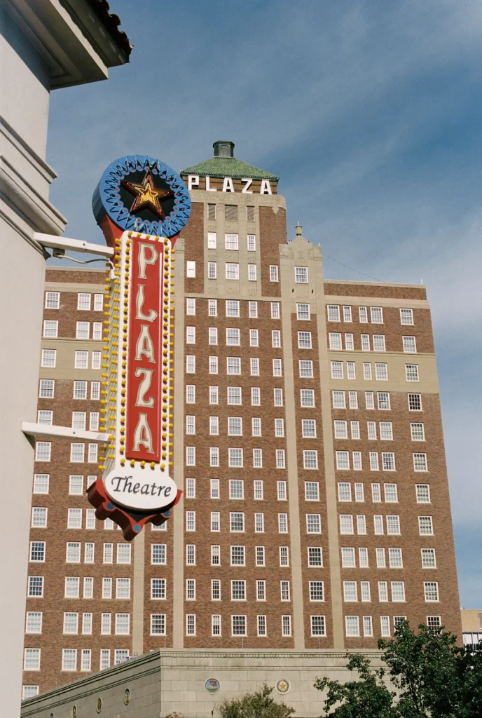 Art deco Plaza Hotel building behind the neon Plaza Theatre sign in El Paso, Texas