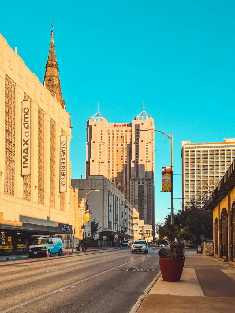 San Antonio downtown street scene looking toward the Marriott Rivercenter hotel tower under a clear blue sky