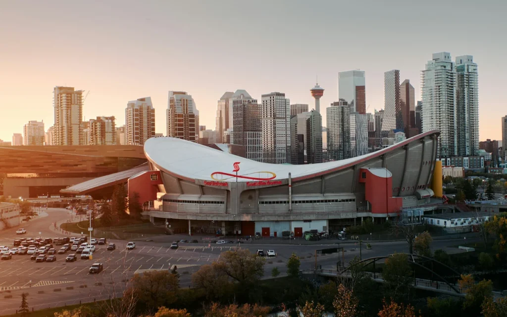Scotiabank Saddledome arena with the Calgary skyline behind it