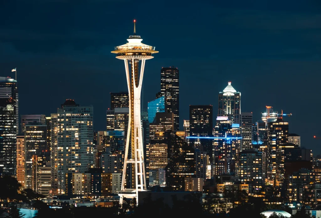 Illuminated Space Needle and downtown skyscraper skyline at night in Seattle