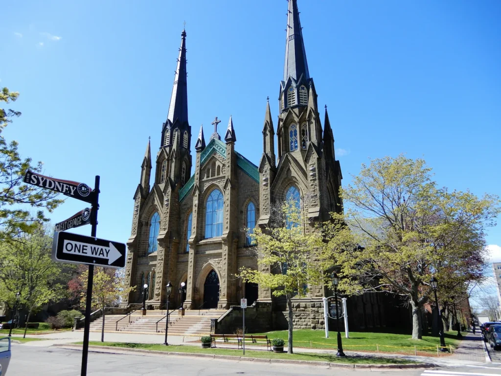 Twin spires of St. Dunstan's Basilica behind a Sydney and Great George street sign