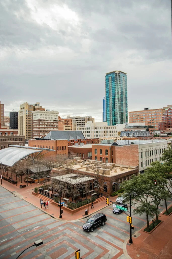 High-angle view of Sundance Square plaza buildings and Bank of America Tower under cloudy skies in Fort Worth, Texas