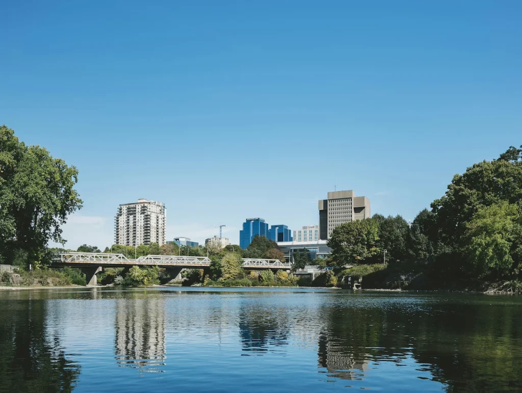A bridge over the Thames River with the London, Ontario skyline