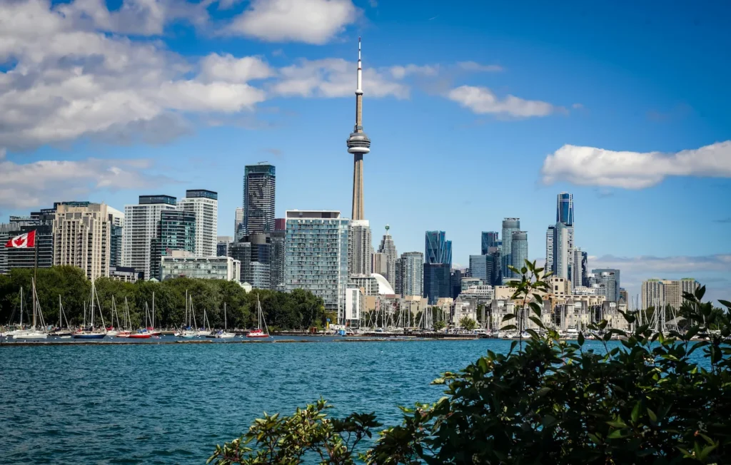 Toronto skyline featuring the CN Tower behind a marina on Lake Ontario