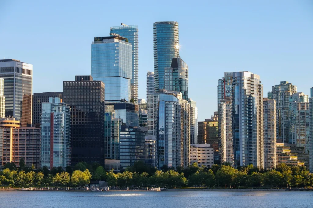 Modern glass skyscrapers making up the downtown Vancouver skyline viewed across the water from Stanley Park