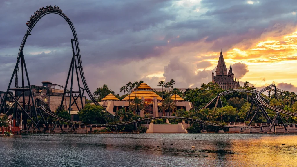 The twisted black tracks of the Jurassic World VelociCoaster towering over the lagoon at Universal Islands of Adventure in Orlando Florida