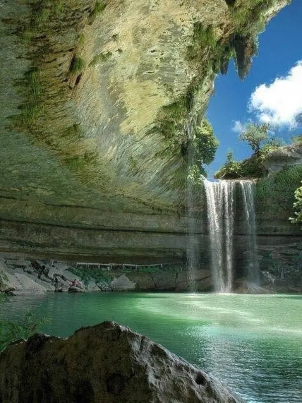 Waterfall flowing into a turquoise pool at Hamilton Pool.
