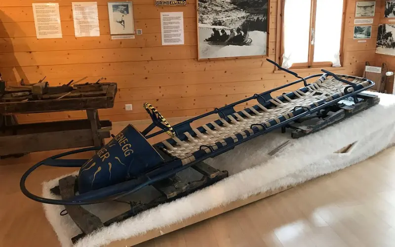 An old wooden sled is displayed inside the Grindelwald Museum.
