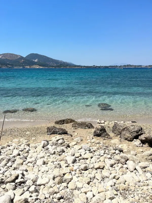 Rocky shoreline and clear waters at Marathonissi.