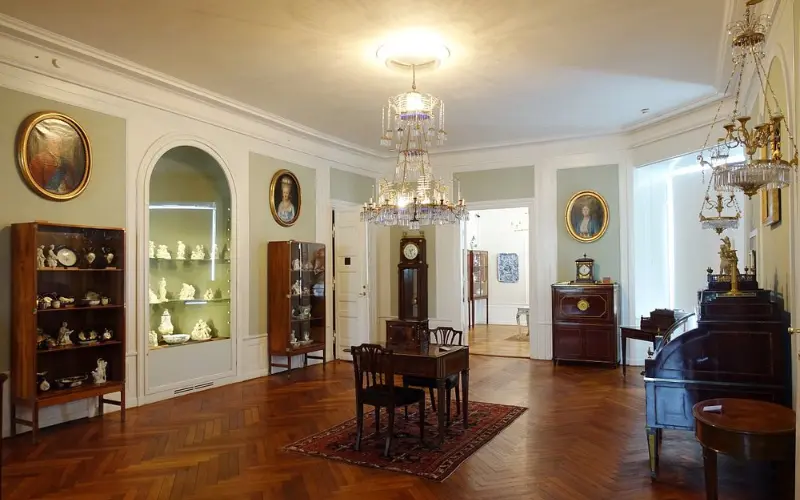 Elegant gallery room with antique furniture at the David Collection.