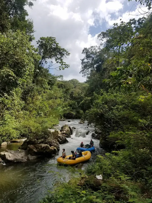 People rafting on a river in Río Plátano Biosphere Reserve.