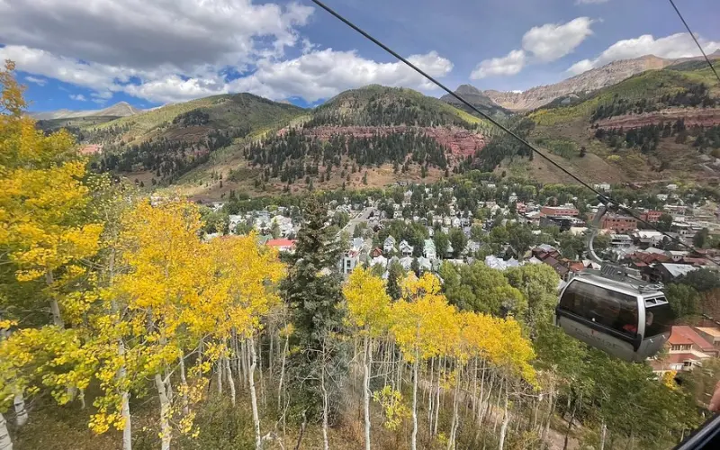 The Mountain Village Gondola overlooking Telluride and fall foliage.