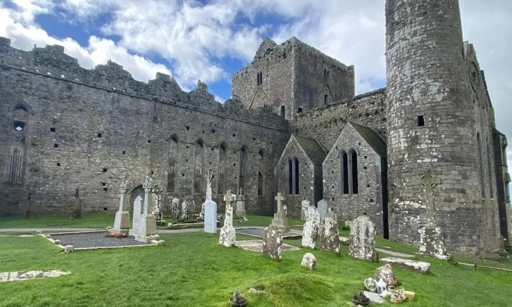 The Rock of Cashel shows ancient stone buildings and a cemetery with Celtic crosses.