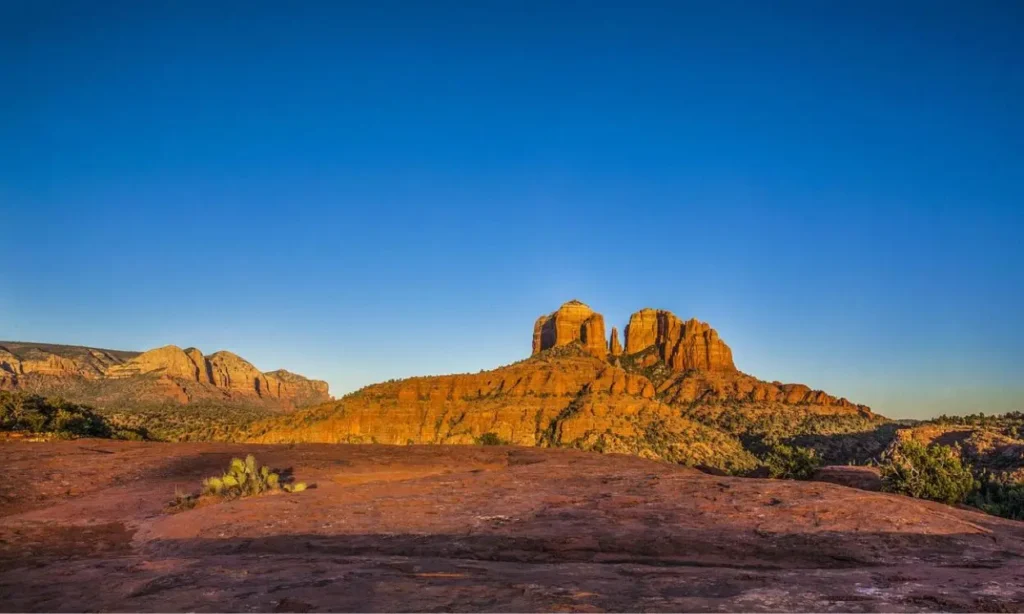 The red rock formations of Sedona, Arizona under a clear blue sky.