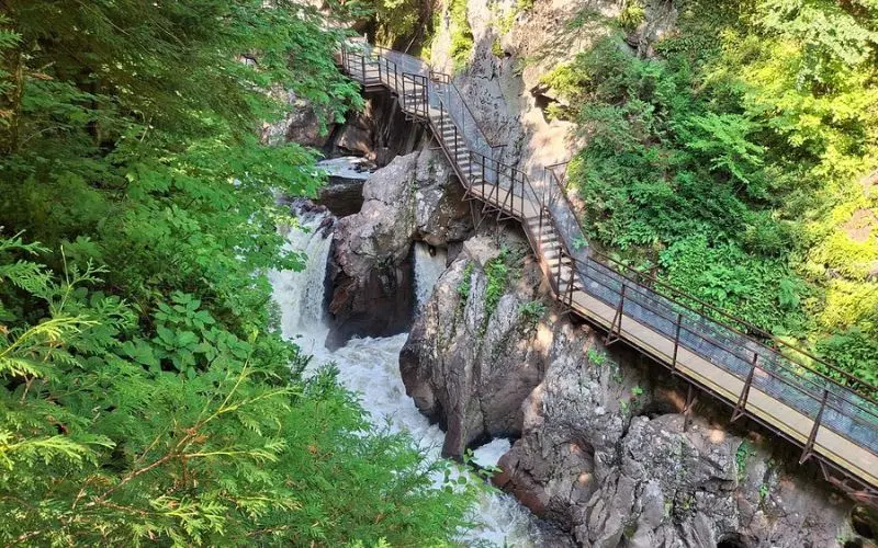Wooden walkway along waterfalls and cliffs at High Falls Gorge.