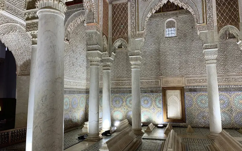Decorated chamber with arches and tombs inside the Saadian Tombs in Marrakech.