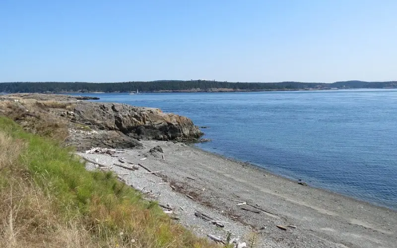 White Cattle Point Lighthouse on a rocky bluff overlooking the water.