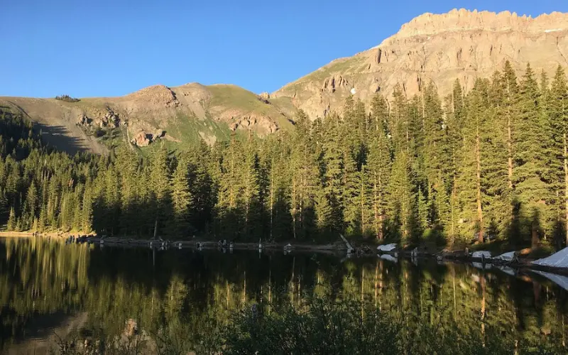 Alta Lakes reflecting pine trees and mountain peaks.