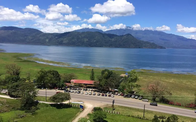 Scenic view of Lake Yojoa with mountains in the background.