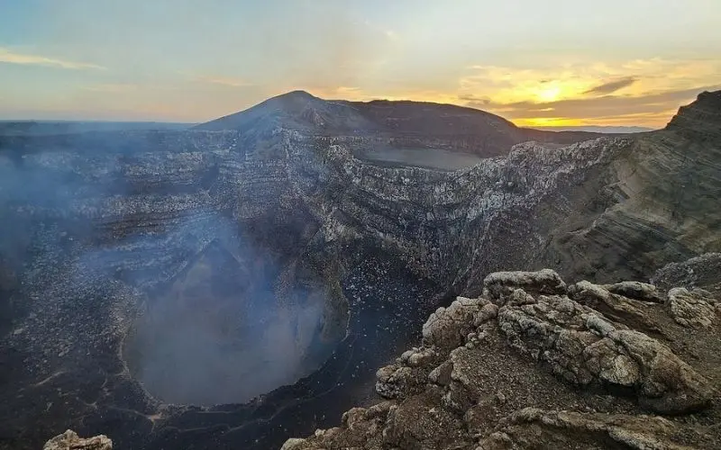 Smoky crater of Masaya Volcano at sunset.
