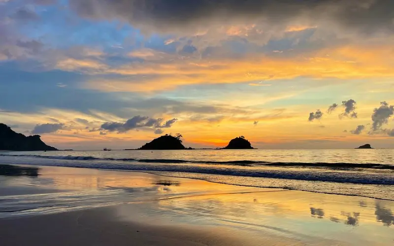 Golden sunset reflecting on the waves at Nacpan Beach.