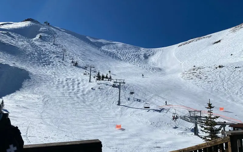 Skiers riding lifts at Telluride Ski Resort on snowy slopes.
