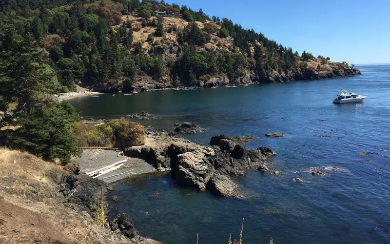 Rocky shoreline and a boat in the water at Friday Harbor.