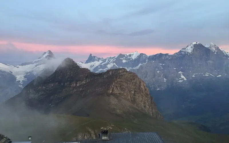 A sunset sky glows pink over the Faulhorn and surrounding mountains.